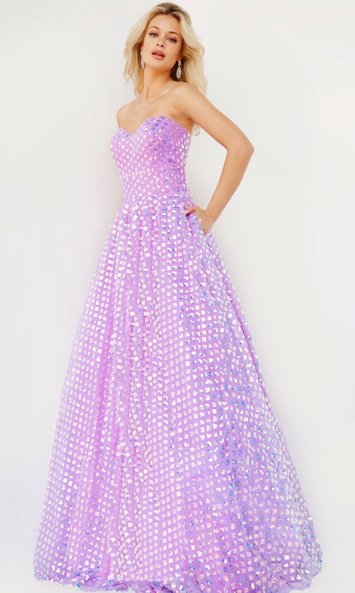 A woman poses in the Jovani Strapless Sweetheart Long Prom Dress 08605, showcasing its iridescent lavender fitted bodice and full skirt, against a light background.